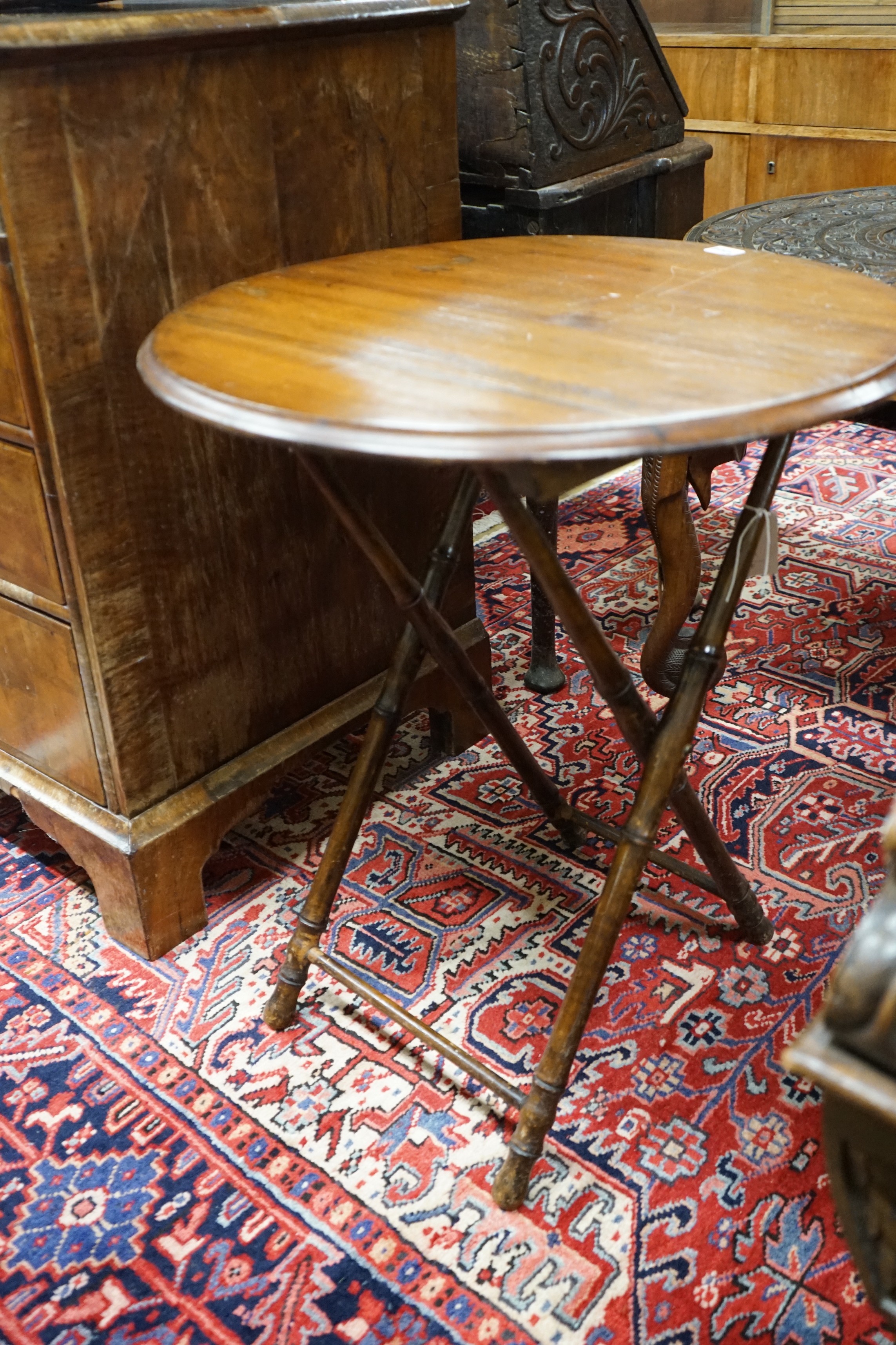 An early 20th century circular beech folding occasional table on faux bamboo underframe, diameter 60cm, height 70cm